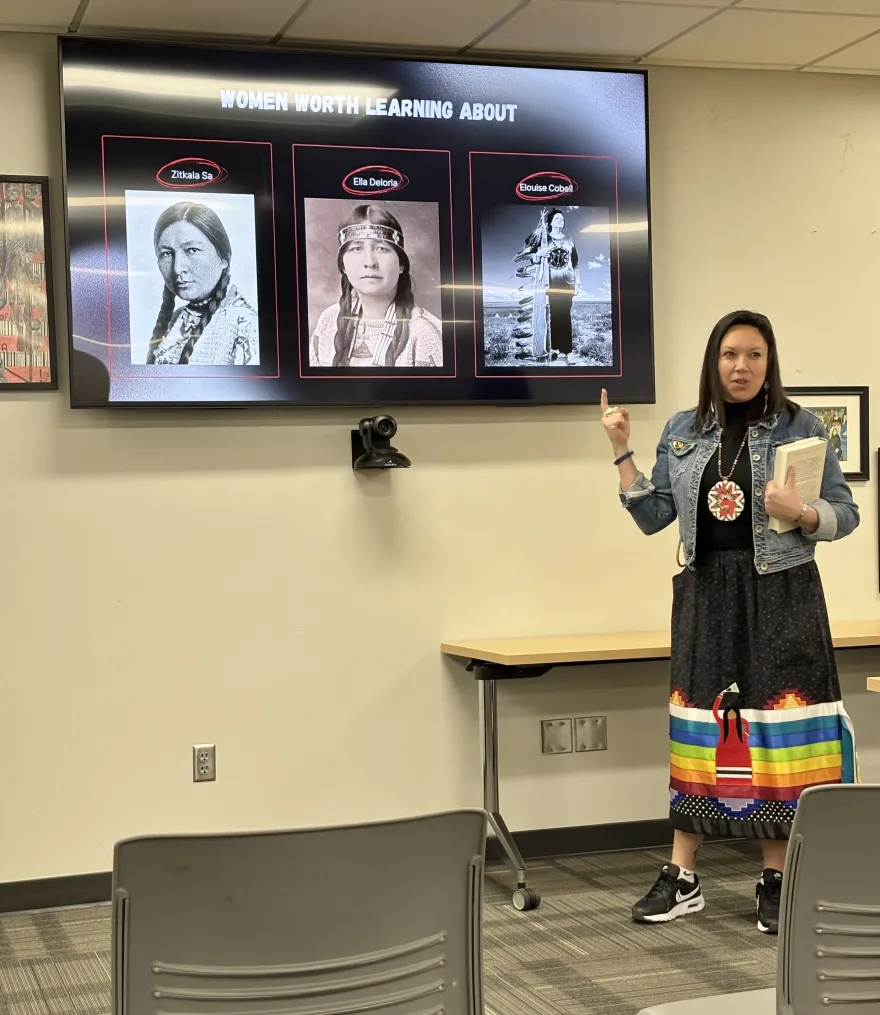 a photo of Heather Keeler giving her Women's History Month presentation in the Campus Center. 