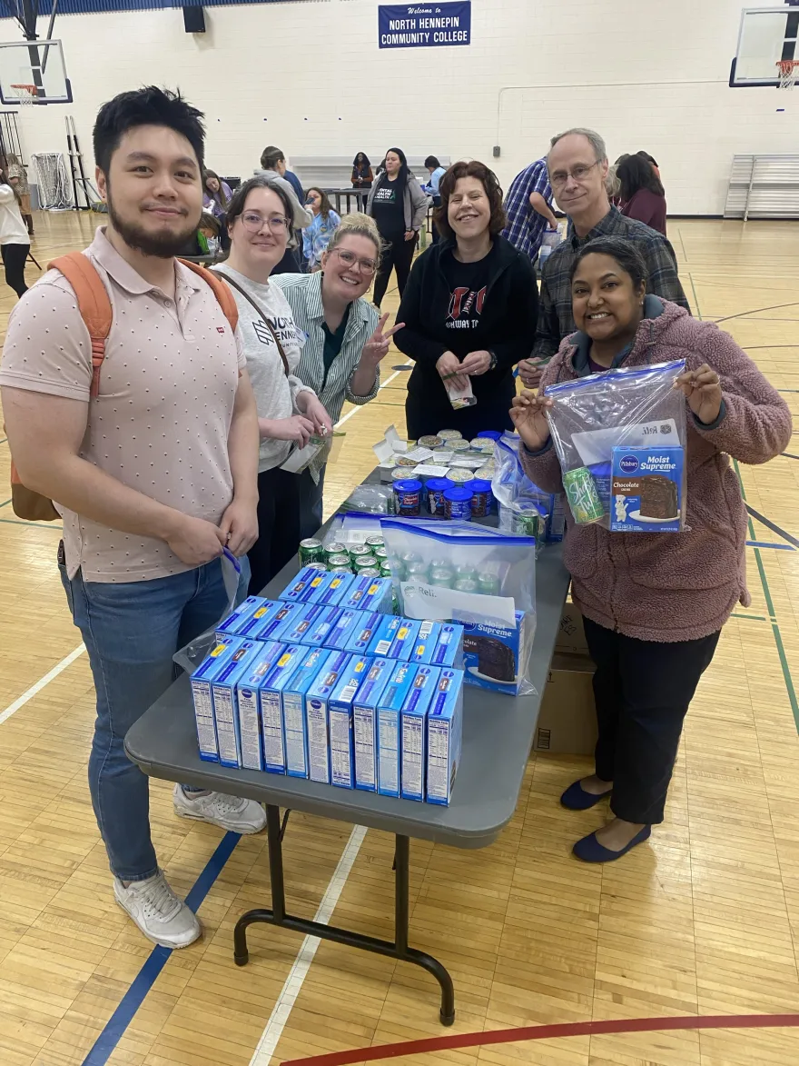 a photo of NHCC staff packing kits to donate in the gym. 