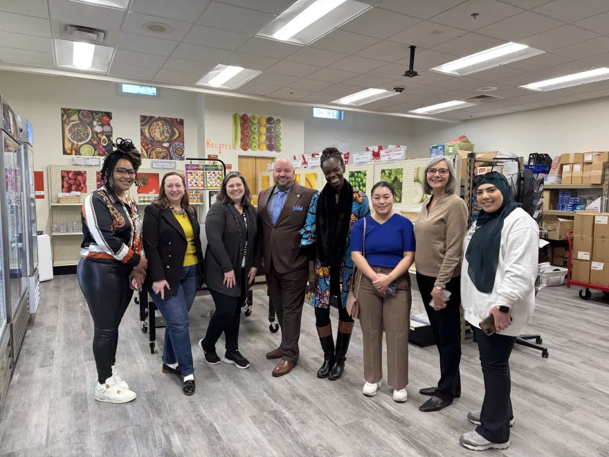 a group photo of NHCC students and administrators with local legislators in the Food Cupboard on-campus. 