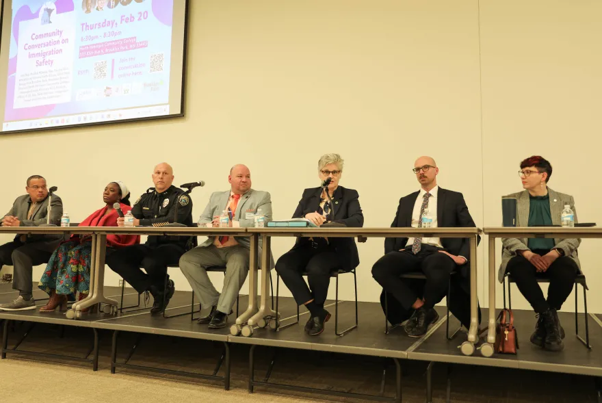 a photo of Rolando and Mary Moriarty sitting side by side for an immigration safety panel event at NHCC.