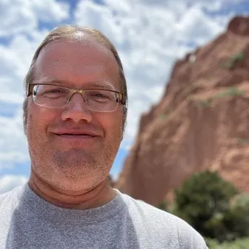 man standing outside near a mountain 